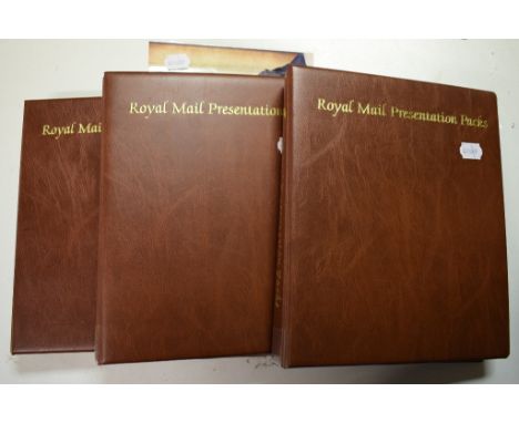 A collection of presentation packs, a small group of first day covers and other stamps, in three albums and loose (7)