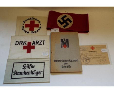 A German Red Cross armband, another DRK ARZT, other armbands, a German First Aid book, and a Red Cross (Personalausweis) iden