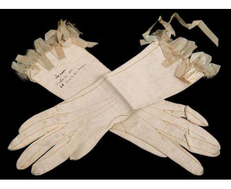 A pair of kid leather gloves, with lace and ribbon detail, inscribed Queen Victoria 1st 22 year of her reign, reputedly worn 