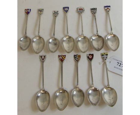 A matched set of twelve silver teaspoons, each finial with an enamel crest of an Oxford University college, the bowls engrave