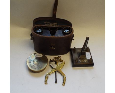 A desk top obelisk thermometer, Battle of Breville 8-13 June 1944, a brass shell ashtray, a pair of MOD binoculars, in a leat
