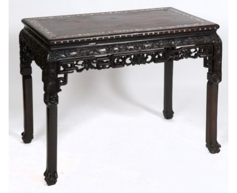 A Chinese hardwood table, inlaid with mother of pearl, carved and pierced scrolls and foliage, 96 cm wide  See inside front c