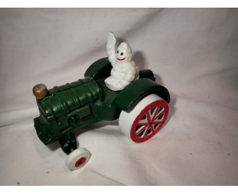 Cast iron Michellin Man on a tractor. H:80mm. UK P&amp;P Group 1 (£16+VAT for the first lot and £2+VAT for subsequent lots) 