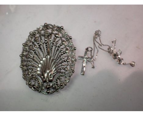 Continental silver shell brooch and silver cross on a chain. UK P&amp;P Group 1 (£16+VAT for the first lot and £2+VAT for sub