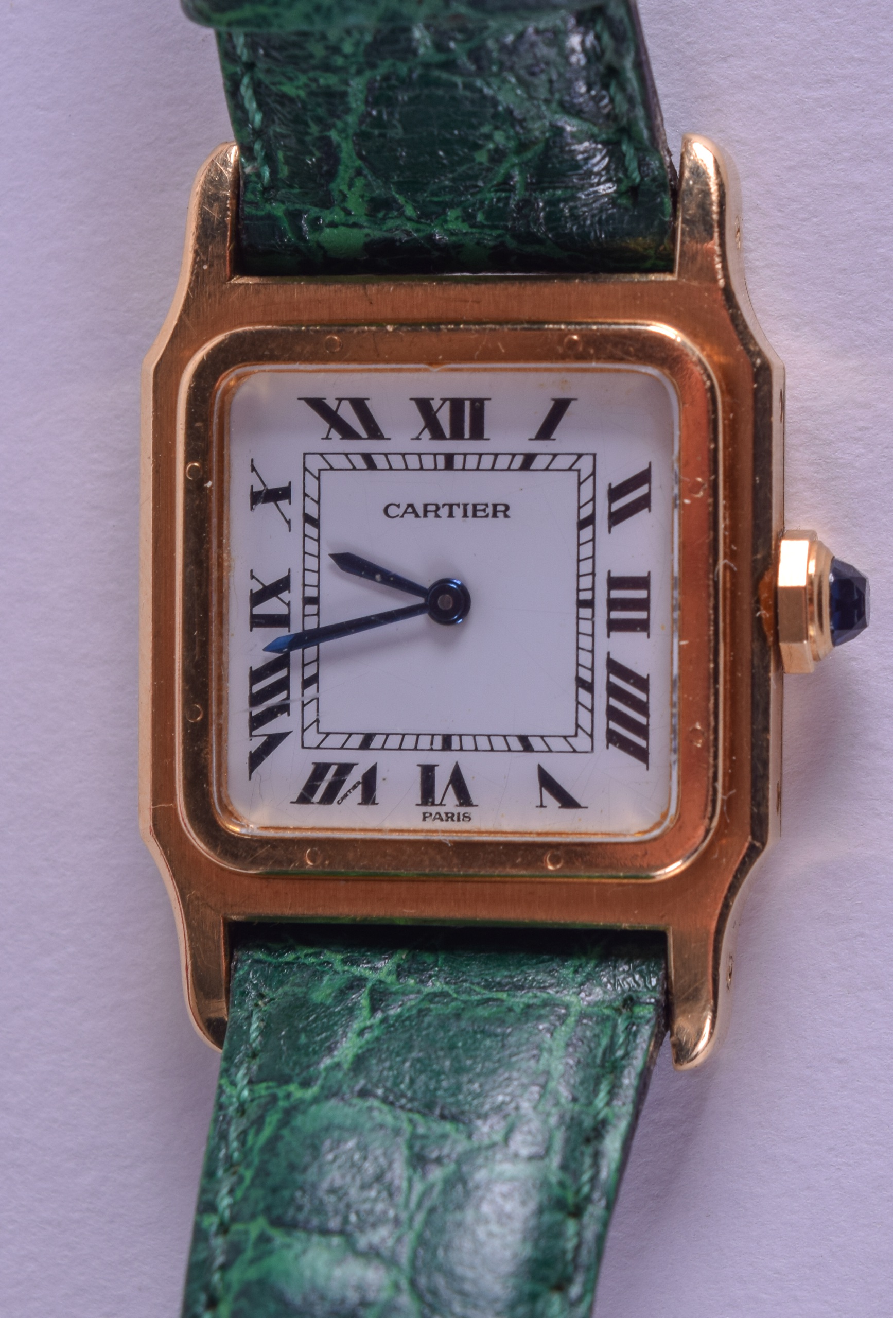 AN 18CT GOLD CARTIER WRISTWATCH with green leather strap. 2.25 cm x 2.5 cm.