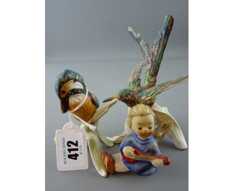 Two Goebel china bird figurines one of a kingfisher and a small Goebel angelic figurine playing a musical instrument