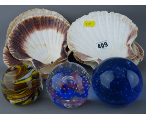 Ten undecorated scallop shells and three small paperweights including a Caithness Collector's Club 'Reflections 95'