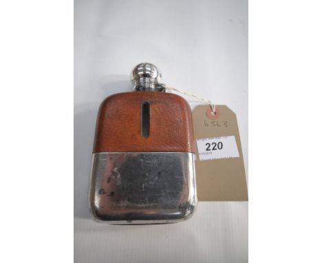 An Early 20th century silver plated and half leather hip flask.
