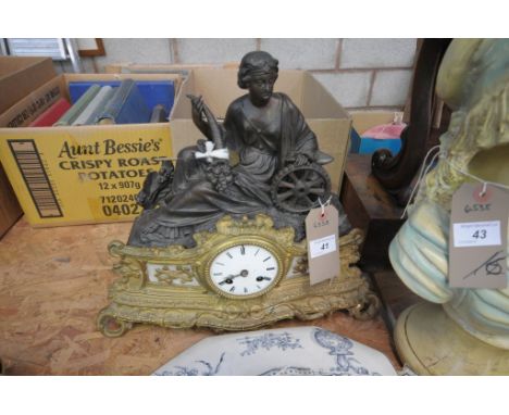 A  French gilt metal and spelter figural mantel clock with a white enamelled dial and Roman numerals.