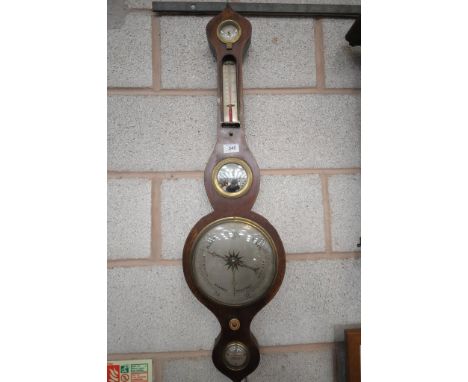 A 19th century mahogany onion topped wall barometer with a silvered dial.