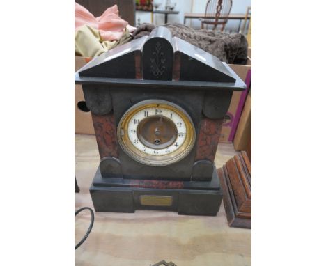 A Victorian slate and rouge marble mantel clock.