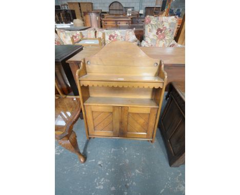 A Light oak hanging wall cabinet with an enclosed shelf above 2 cupboard doors.