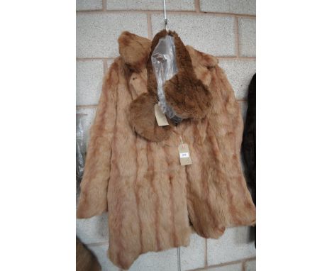 A Musquash fur half length coat with collar and lapel also a rabbit fur stole dyed brown with rounded fan shaped ends , both 