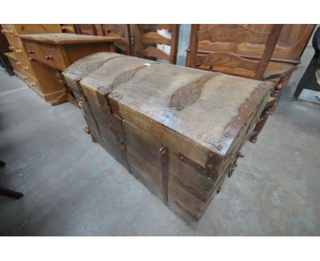 A 17th Century iron bound oak domed trunk
Flanked by twin carrying handles, some restoration and further damage throughout, w