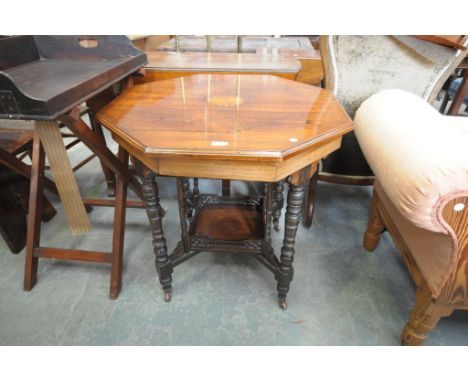 A Victorian rosewood octagonal centre table centred with an inlaid fan above a galleried undershelf.