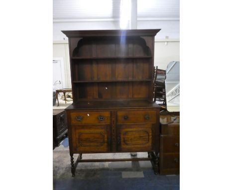 An Edwardian Oak Two Drawer Dresser with Cupboard Base and Two Shelf Plate Rack, 121cm Wide 