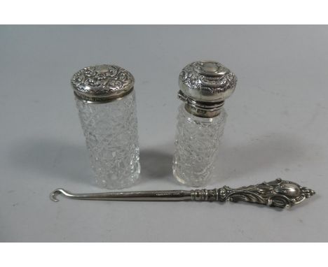 A Silver Mounted Button Hook and Two Silver Topped Scent Bottles 
