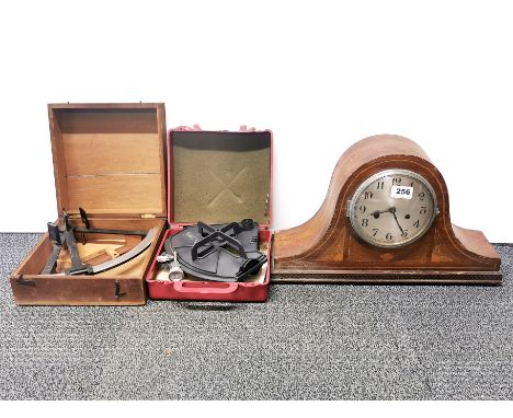 An inlaid striking mantel clock, W. 45cm, together with two sextants.