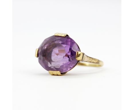 A yellow metal (tested minimum 9ct gold), set with a large oval cut amethyst, (K.5).