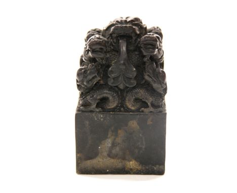 A heavy Chinese cast bronze scholar's seal decorated with dragons, H. 14cm.