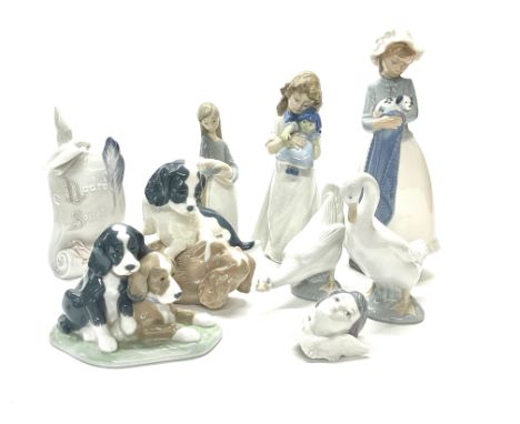 A group of Nao porcelain figures, tallest H. 25cm, with a Lladro society plaque.