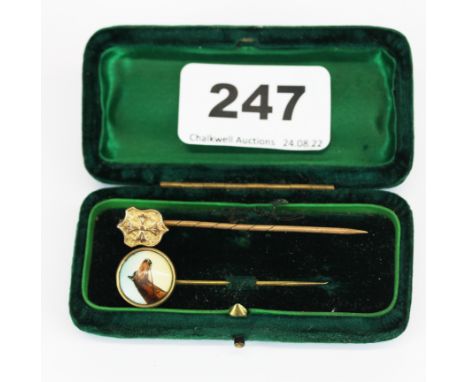 A boxed antique yellow metal stick pin with horse enamel with a further stick pin, longest L. 6cm.