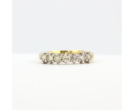 An 18ct yellow gold ring set with brilliant cut diamonds, (N), approx. 0.70ct total.