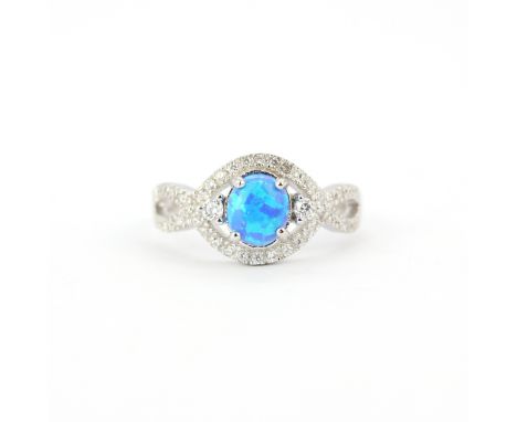 A 925 silver ring set with a oval cabochon cut synthetic opal surrounded by cubic zirconias, (R ).