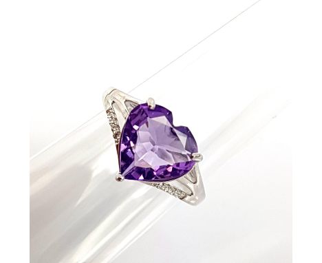 A 925 silver adjustable ring set with a heart cut amethyst and white stones.