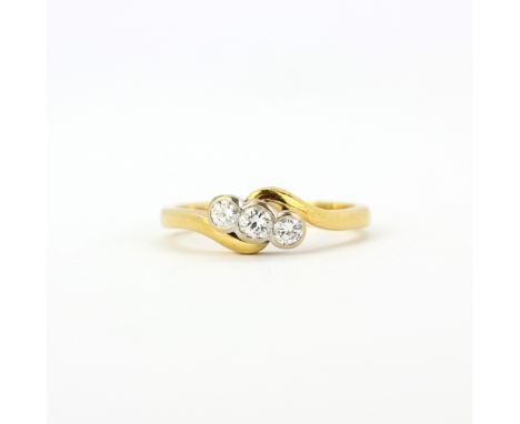 An 18ct yellow gold ring set with three rub over brilliant cut diamonds, (N).