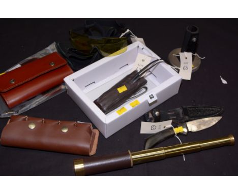 A Browning hunting knife, with single edged drop point blade and shaped wooden handle, in leather sheath; together with two b