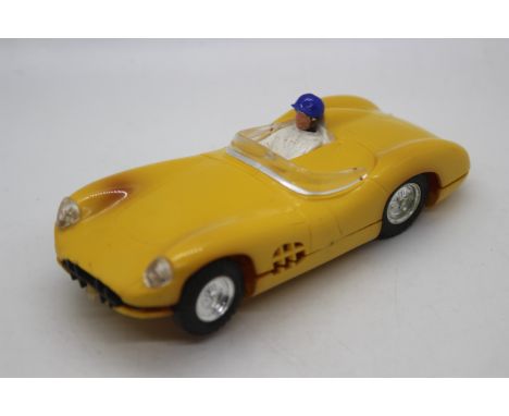 Scalextric (France) - A French made lighted version Scalextric C57 Aston Martin DBR1. The model in yellow with yellow tonneau