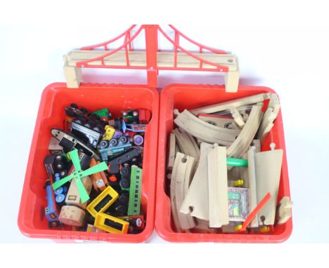 A large collection of wooden trains featuring Brio Thomas the tank engine and friends models and a box of wooden tracks. Item
