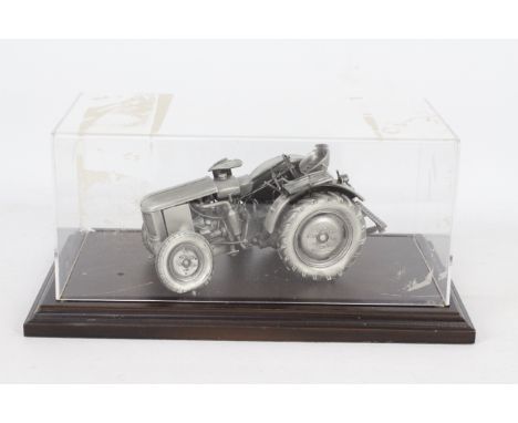 Unknown Maker - A pewter die-cast Deutz model tractor. Item appears to be in good condition on a wooden base, some slight scu