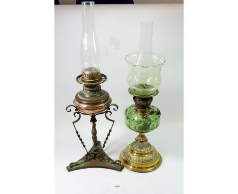 A Victorian brass oil lamp with green glass reservoir and shade and a copper oil lamp on brass and copper stand 