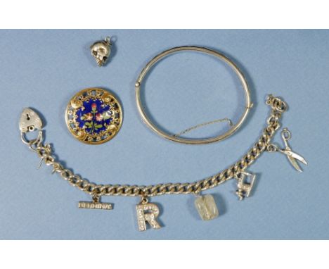 A silver hinged bangle and a silver bracelet plus various metal charms and an enamel French button 