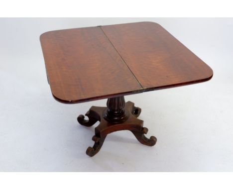 A Victorian Mahoney fold over card table with tulip carved pedestal on platform base 