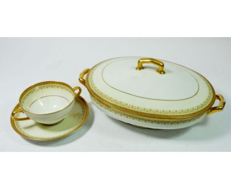 A Limoges C Ahrenfeldt gilt and white dinner service comprising:- seven dinner plates, seven side plates,seven tea plates, se