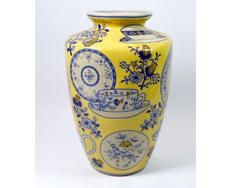 An Oriental vase decorated with teapot, cups, saucers and plates marked The property of Bibby Trade Finance Ltd, 30cm