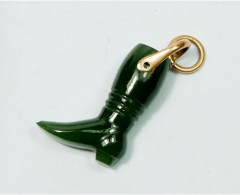 A miniature carved jade boot charm on yellow metal suspension loop 