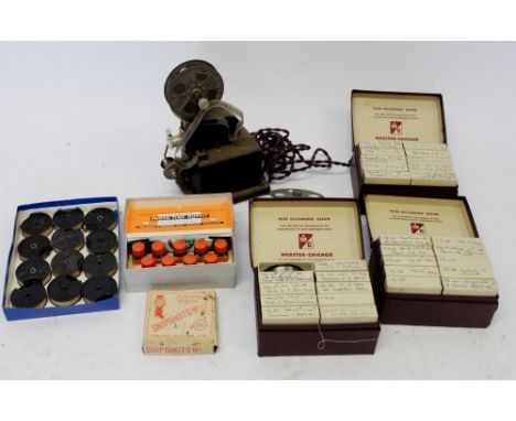 An early cine camera and quantity of Pathescope reels plus a quantity of Webster Wire recording reels boxed 