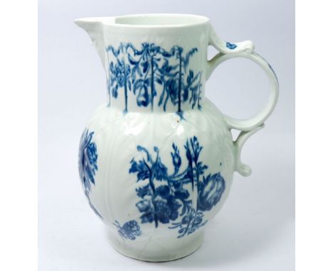 A Worcester first period blue and white mask jug painted floral sprays and butterfly, 22.5cm, crescent mark to base 