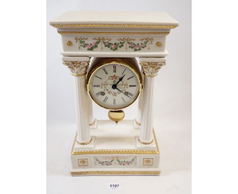 A Franklin Mint floral porcelain Empress Josephine Portico clock, striking on a bell, hairline to top, 36cm tall 