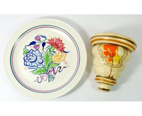 An Art Deco wall pocket painted in the style of Clarice Cliff and a Poole pottery floral plate 