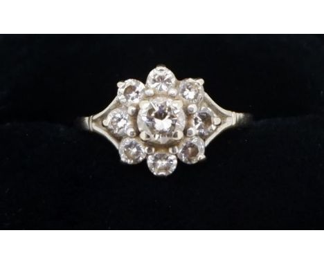 A diamond cluster ring set central stone in eight stone surround, size M to N 