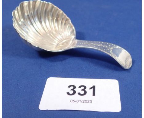 A silver caddy spoon, Sheffield 1932 by Thomas Bradbury with shell bowl and bright cut decoration. 