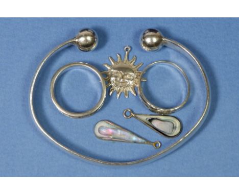 A silver bangle and two silver rings, 41gm plus three silver pendants 