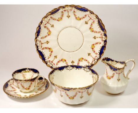 A Royal Albert Edwardian tea service with floral swag decoration comprising: seven cups and two saucers, ten tea plates and a