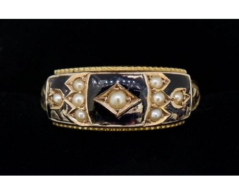 An Edwardian black enamel and 9 carat gold ring set seed pearls, size P 