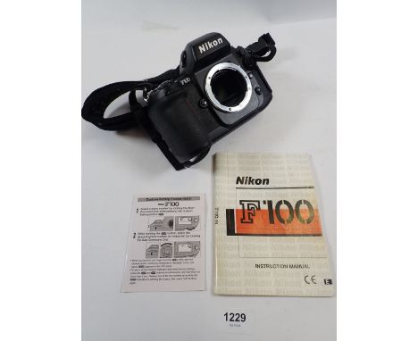 A Nikon F100 camera body with manuals 